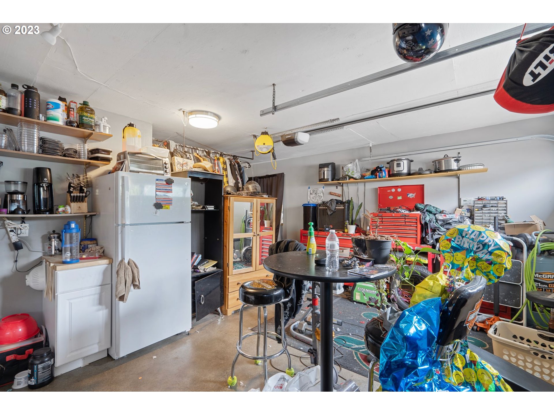 5119 Southeast 68th Avenue Portland, OR 97206 - Photo 20 of 43 a storage room with a refrigerator and a table