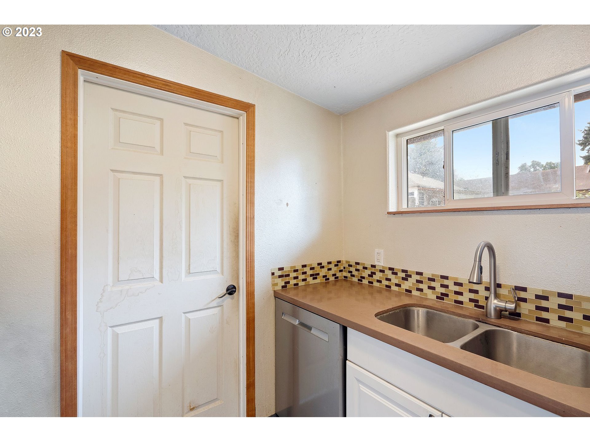5119 Southeast 68th Avenue Portland, OR 97206 - Photo 35 of 43 a kitchen with a sink cabinets and a window
