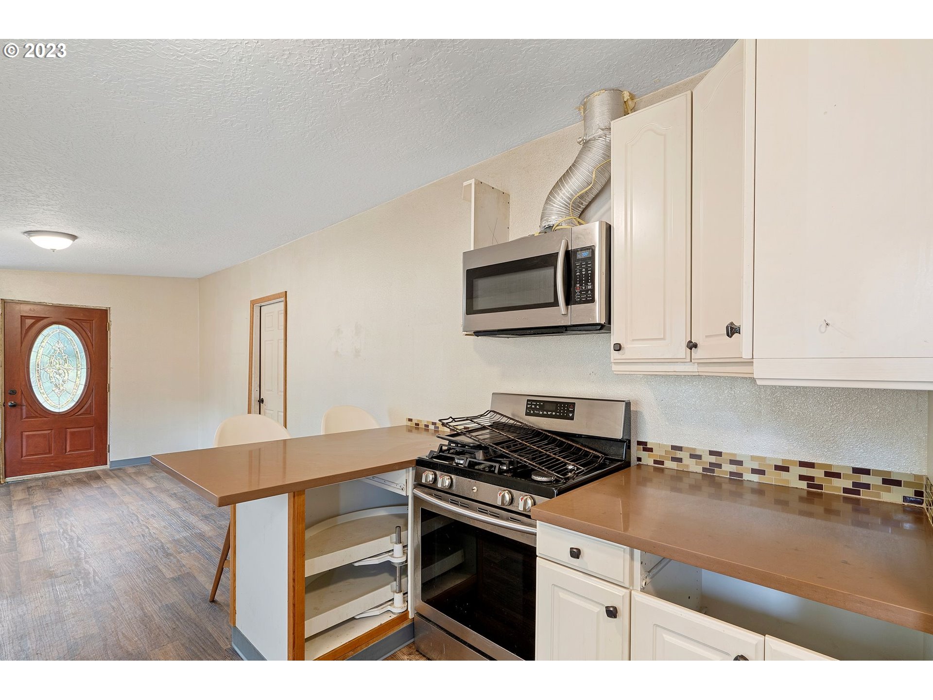 5119 Southeast 68th Avenue Portland, OR 97206 - Photo 36 of 43 a kitchen with a stove and a microwave