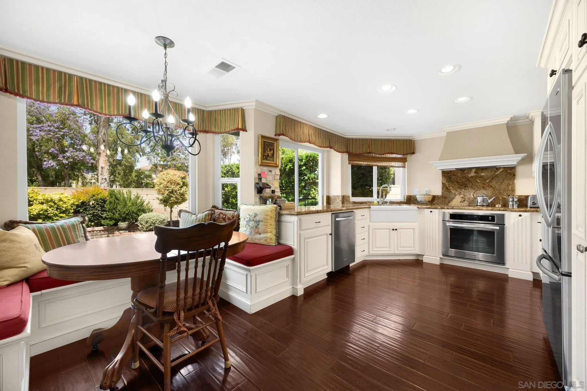 a living room with stainless steel appliances kitchen island granite countertop furniture and a large window