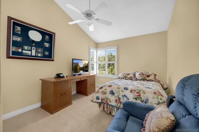 a bedroom with furniture and a flat screen tv