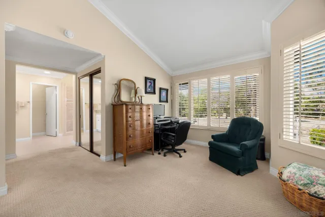 a living room with furniture and large windows