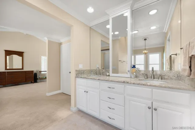 a bathroom with a granite countertop sink mirror and double