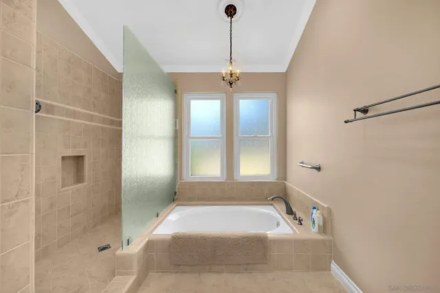 a bathroom with a tub shower and a sink