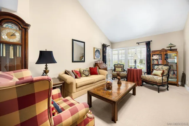 a living room with furniture a rug and a large window
