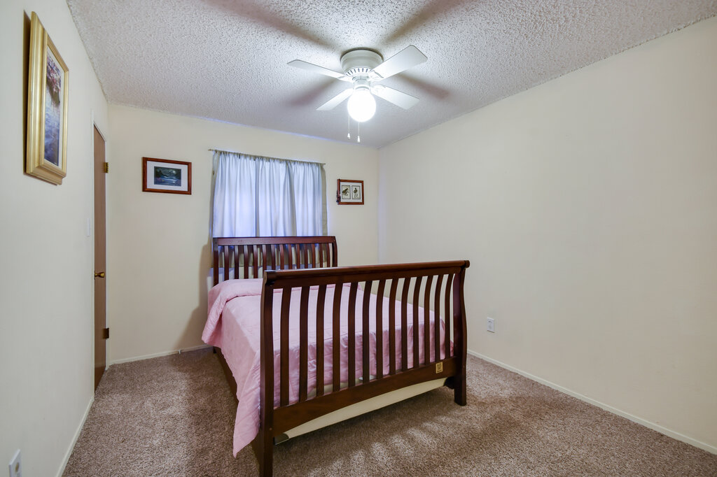 301 Navajo Trail Georgetown, TX 78633 - Photo 33 of 35 Carpeted bedroom with a textured ceiling, a ceiling fan, and baseboards