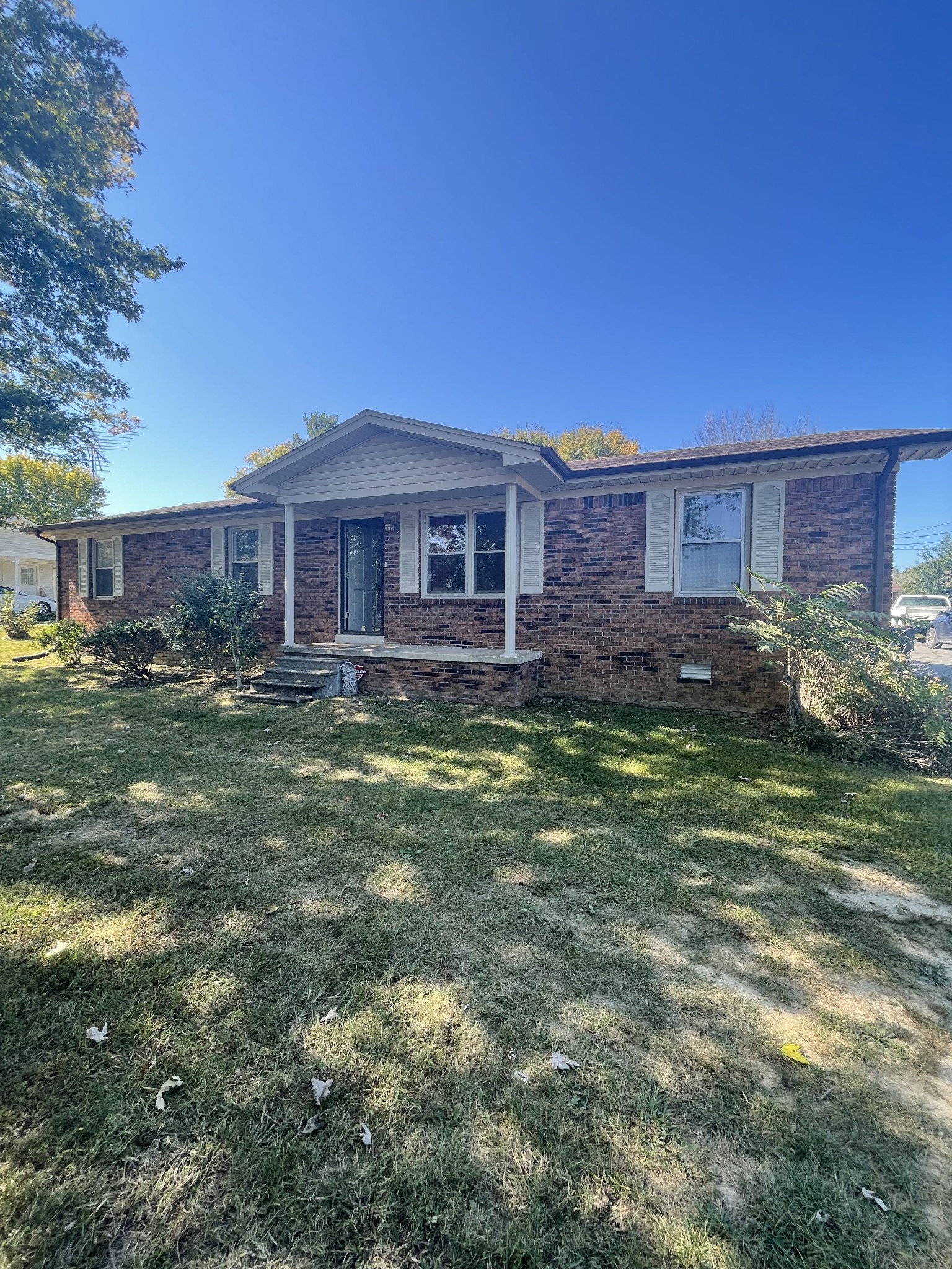 851 Akersville Road Lafayette, TN 37083 - Photo 14 of 29 a front view of a house with a yard table and chairs