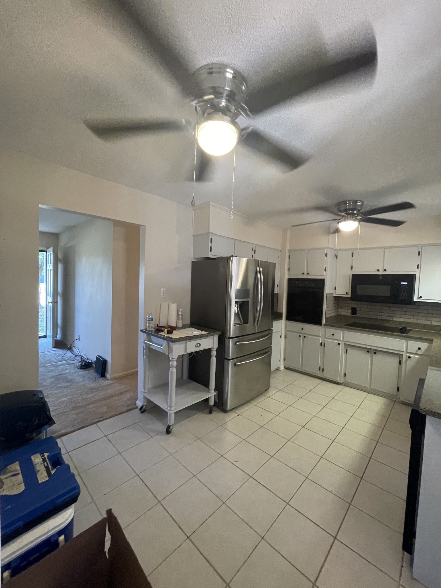 851 Akersville Road Lafayette, TN 37083 - Photo 15 of 29 a kitchen with stainless steel appliances kitchen island granite countertop a sink and a refrigerator