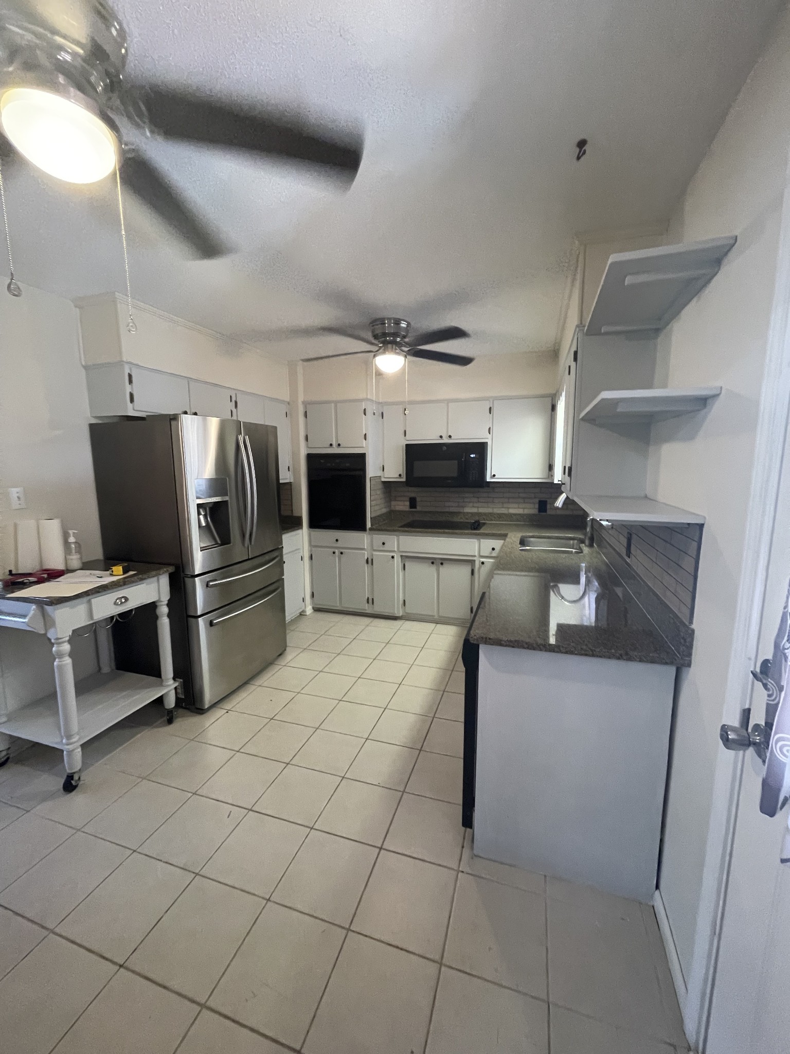 851 Akersville Road Lafayette, TN 37083 - Photo 20 of 29 a kitchen with stainless steel appliances a refrigerator and a stove top oven