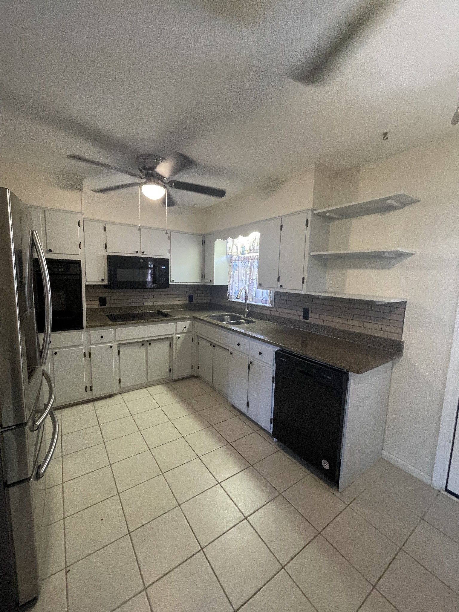 851 Akersville Road Lafayette, TN 37083 - Photo 21 of 29 a kitchen with stainless steel appliances granite countertop a sink counter space cabinets and a sink