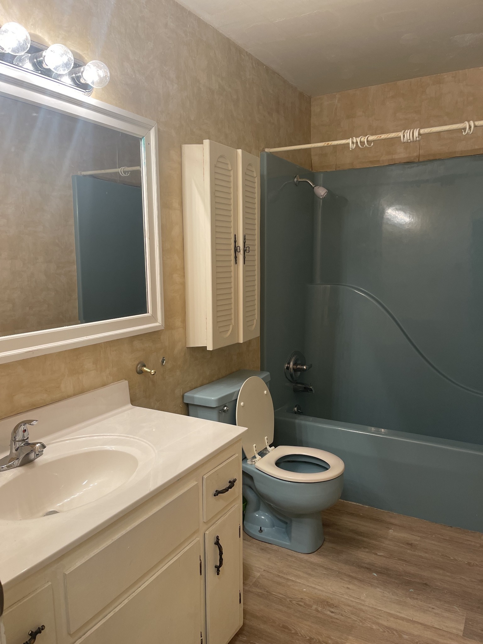 851 Akersville Road Lafayette, TN 37083 - Photo 24 of 29 a bathroom with a granite countertop toilet a sink and a mirror