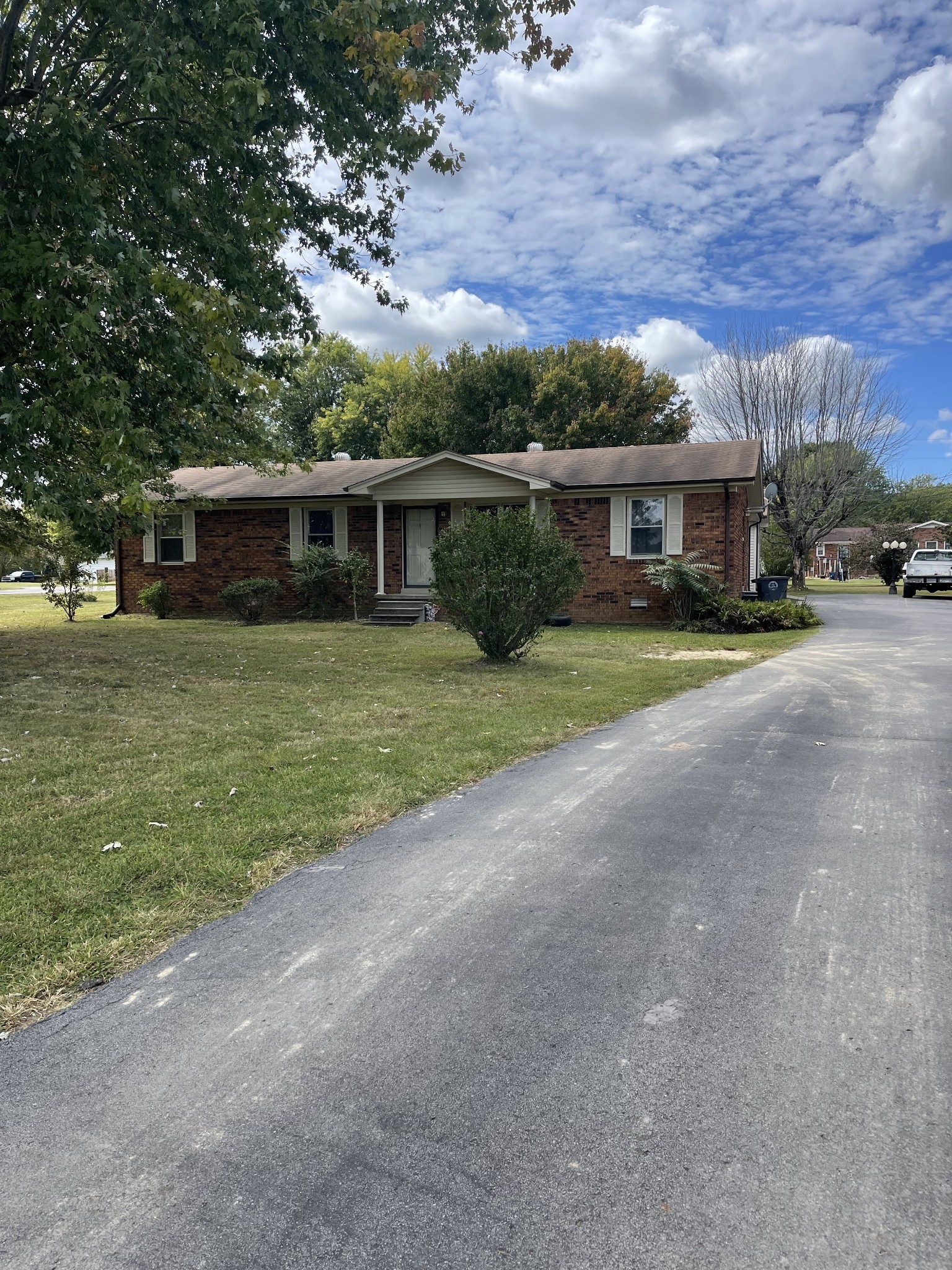 851 Akersville Road Lafayette, TN 37083 - Photo 3 of 29 a view of a house with a yard and large tree
