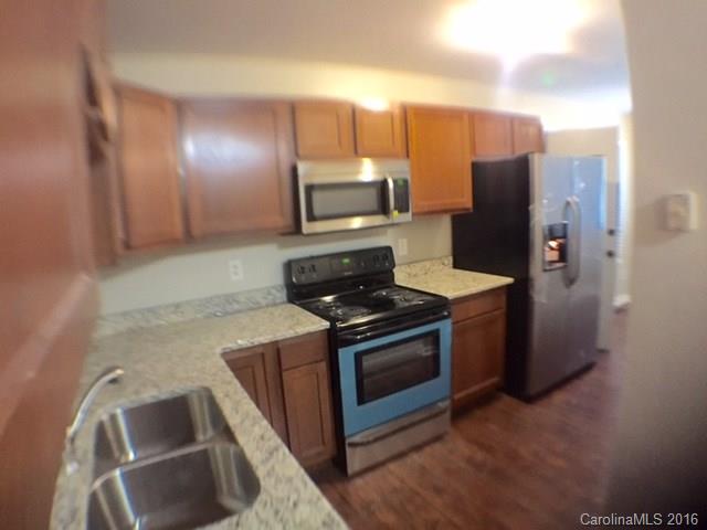 9242 Fairway Ridge Road Charlotte, NC 28277 - Photo 3 of 17 a kitchen with a stove microwave and refrigerator