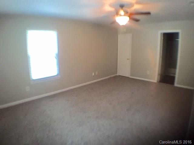 9242 Fairway Ridge Road Charlotte, NC 28277 - Photo 8 of 17 an empty room with a window and a fan
