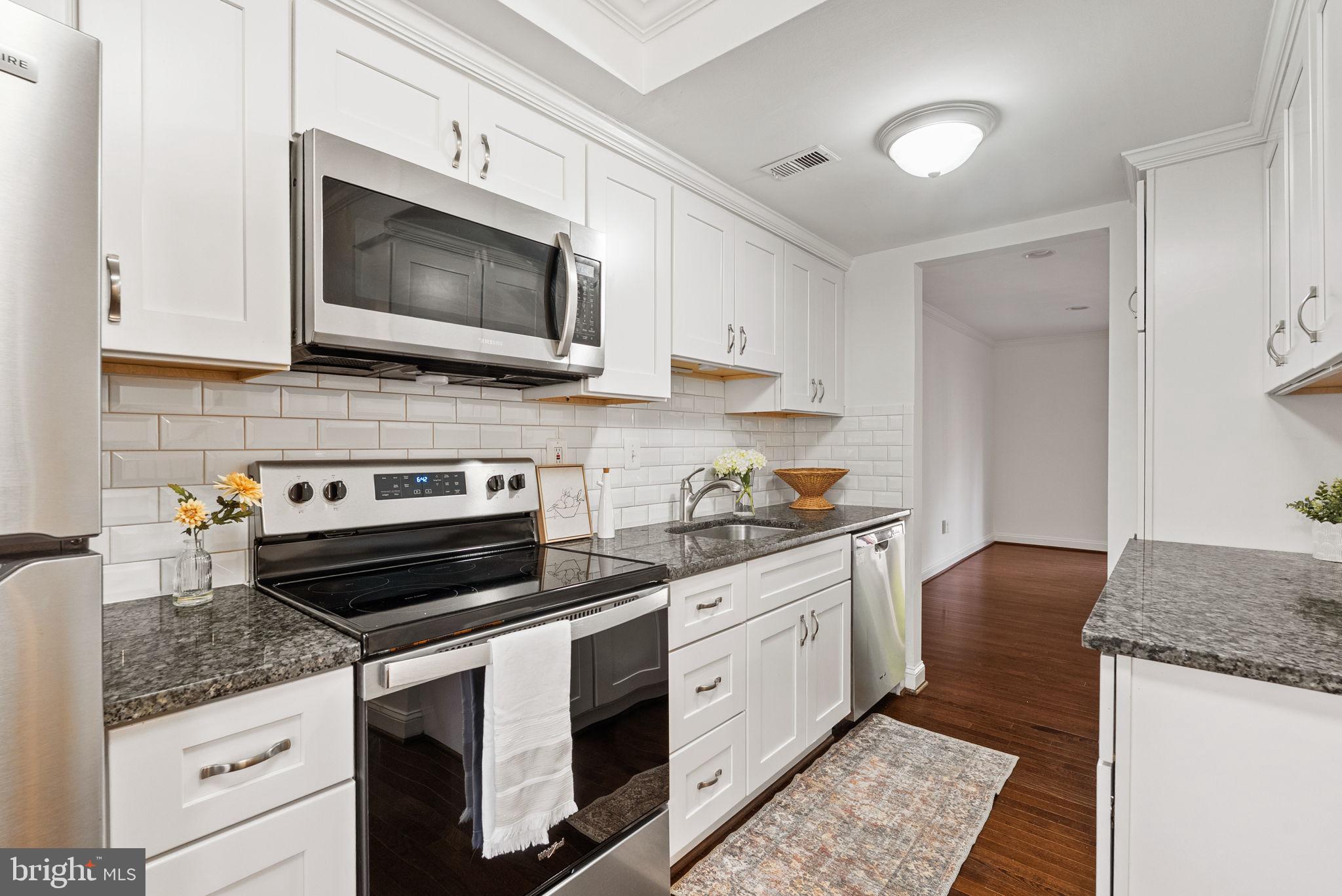 8914 Shamrock Court Springfield, VA 22152 - Photo 12 of 29 a kitchen with a stove and a microwave