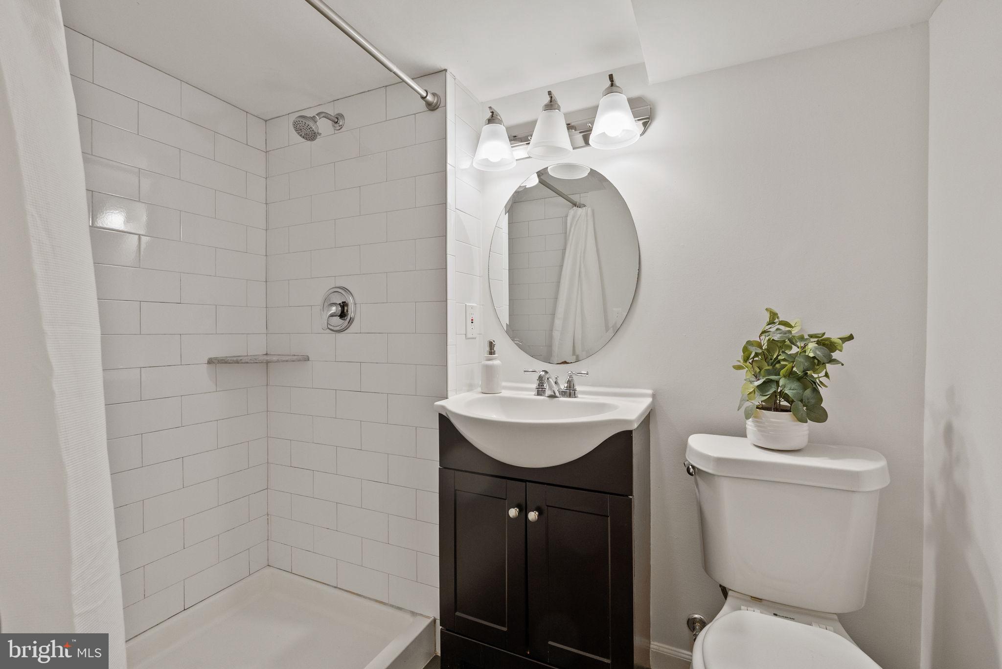 8914 Shamrock Court Springfield, VA 22152 - Photo 27 of 29 a bathroom with a toilet a sink and mirror