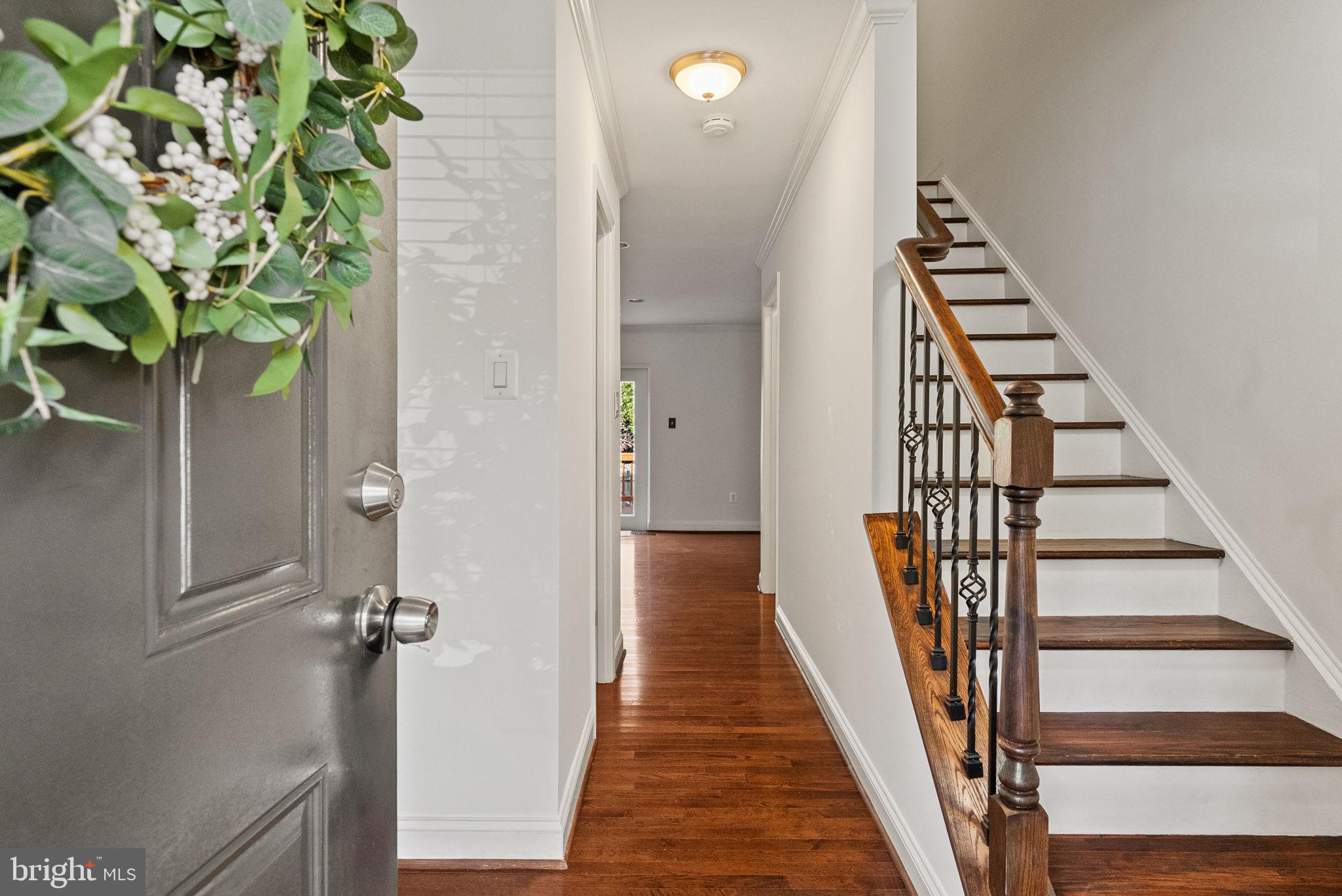 8914 Shamrock Court Springfield, VA 22152 - Photo 5 of 29 a view of a hallway with wooden floor and stairs
