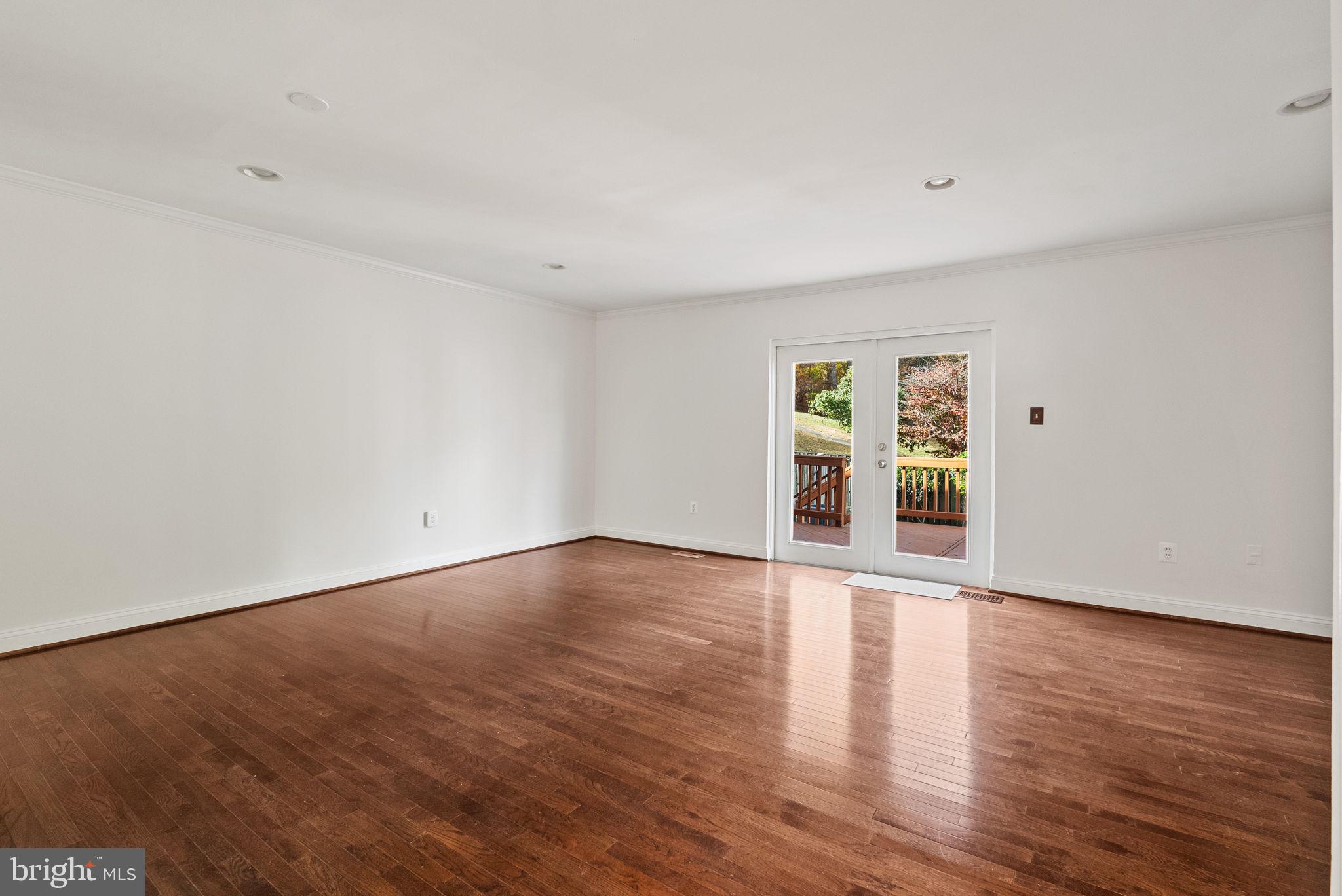 8914 Shamrock Court Springfield, VA 22152 - Photo 7 of 29 a view of an empty room with wooden floor and windows