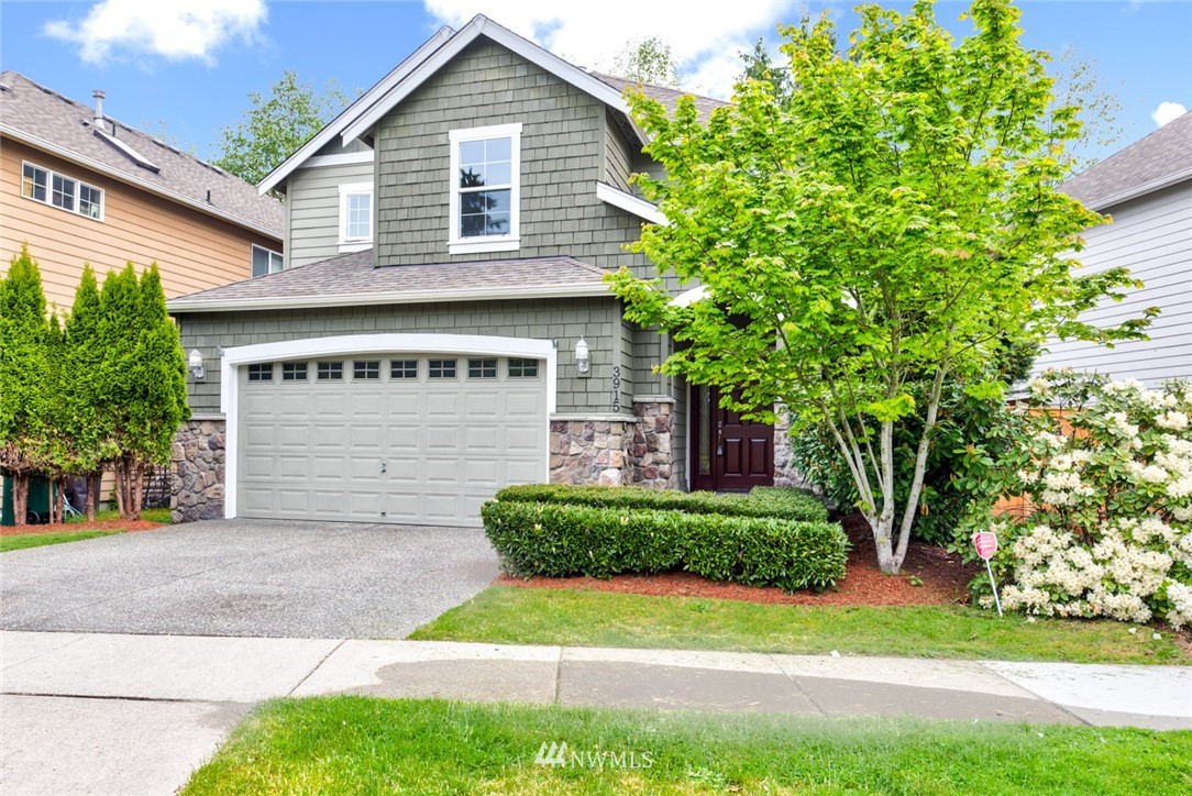 3915 167th Street Southeast Bothell, WA 98012 - Photo 1 of 28 a front view of a house with a yard and garage