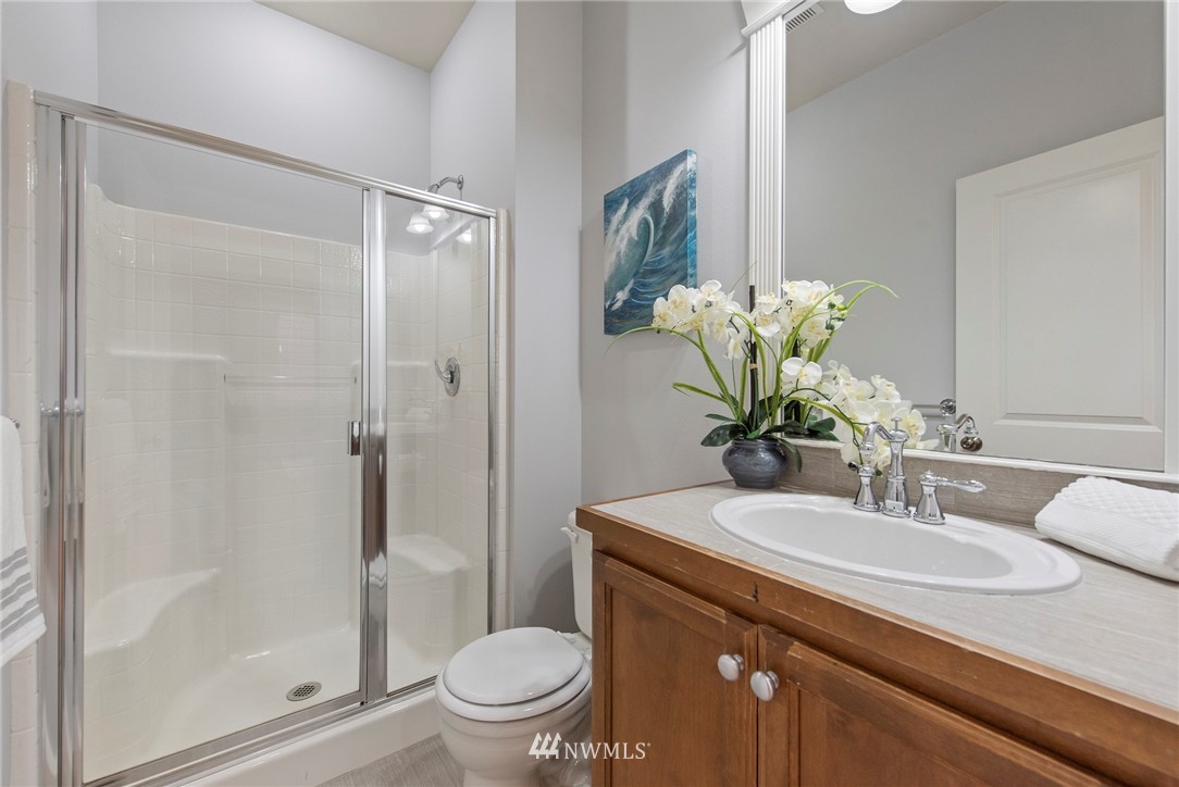 3915 167th Street Southeast Bothell, WA 98012 - Photo 13 of 28 a bathroom with a granite countertop sink a toilet and shower