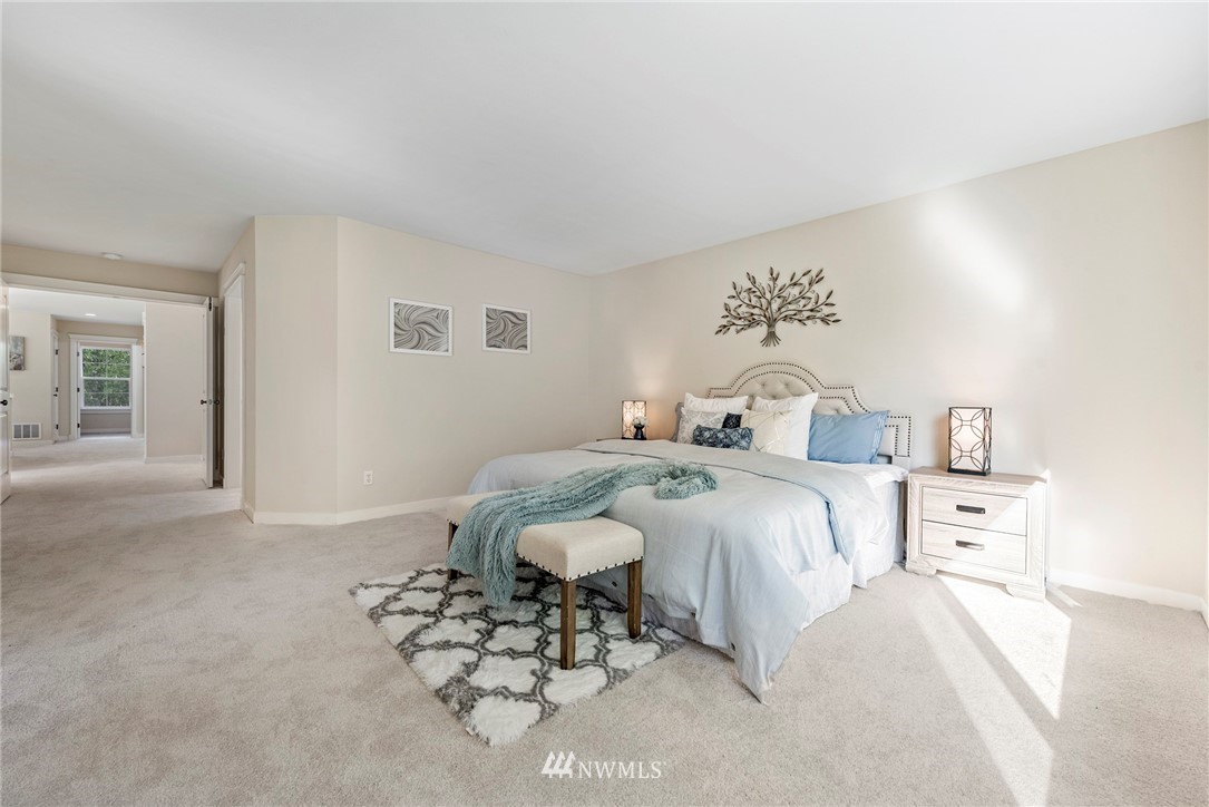 3915 167th Street Southeast Bothell, WA 98012 - Photo 16 of 28 a bedroom with a bed and a chandelier
