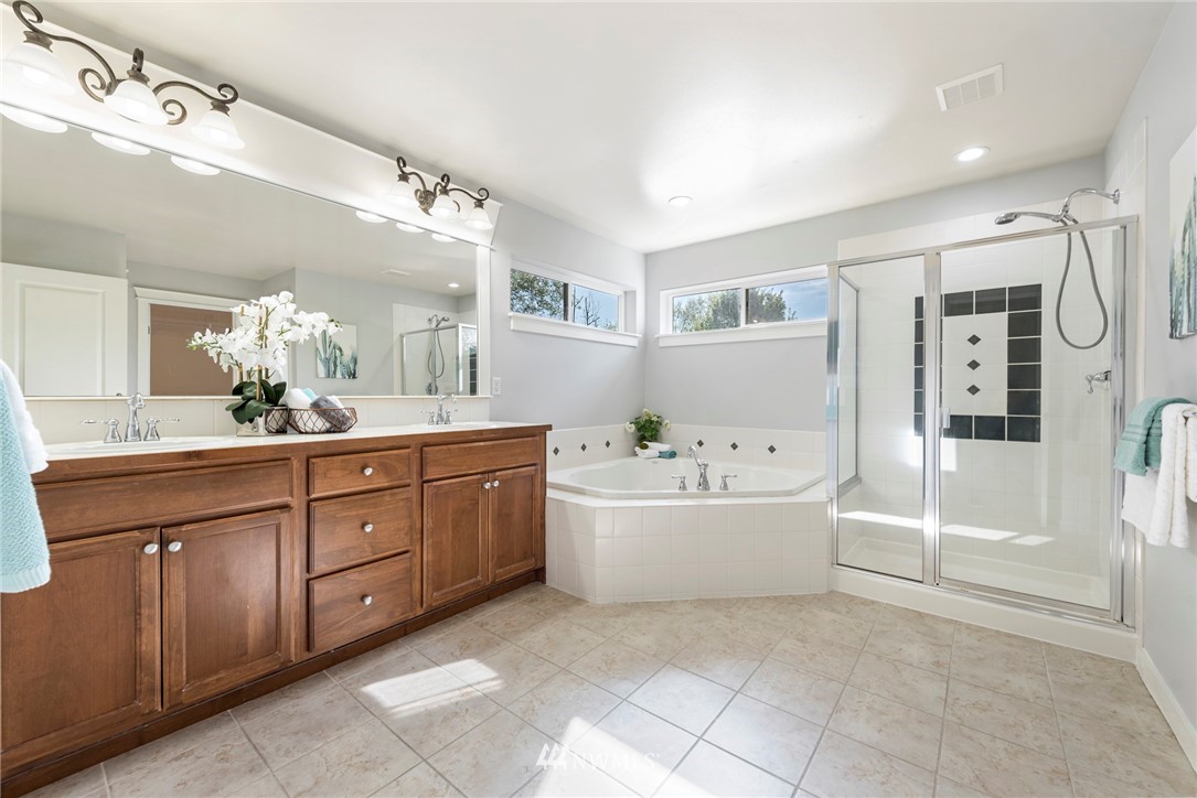 3915 167th Street Southeast Bothell, WA 98012 - Photo 17 of 28 a spacious bathroom with a tub sink and mirror