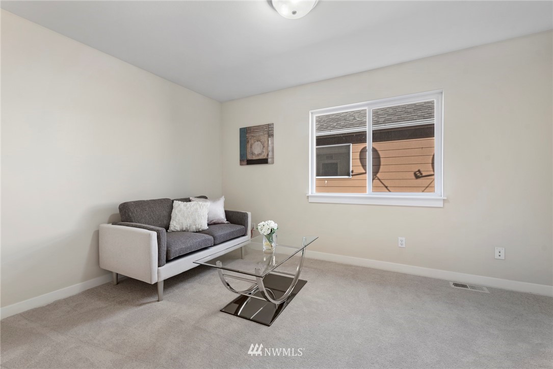 3915 167th Street Southeast Bothell, WA 98012 - Photo 18 of 28 a living room with furniture and a window