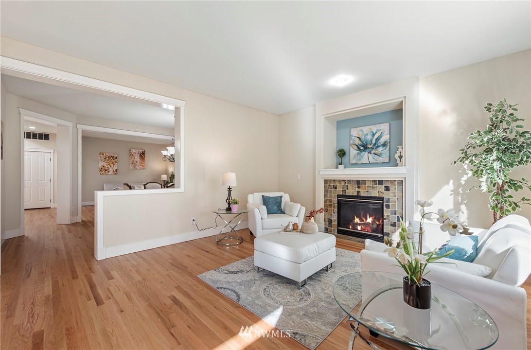 3915 167th Street Southeast Bothell, WA 98012 - Photo 7 of 28 a living room with furniture and a fireplace