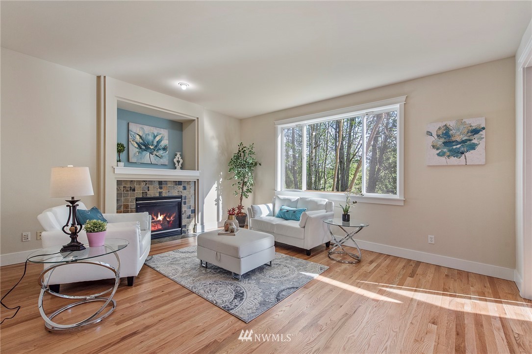 3915 167th Street Southeast Bothell, WA 98012 - Photo 8 of 28 a living room with furniture and a fireplace