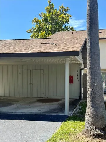 a wooden house with a tree in front of it