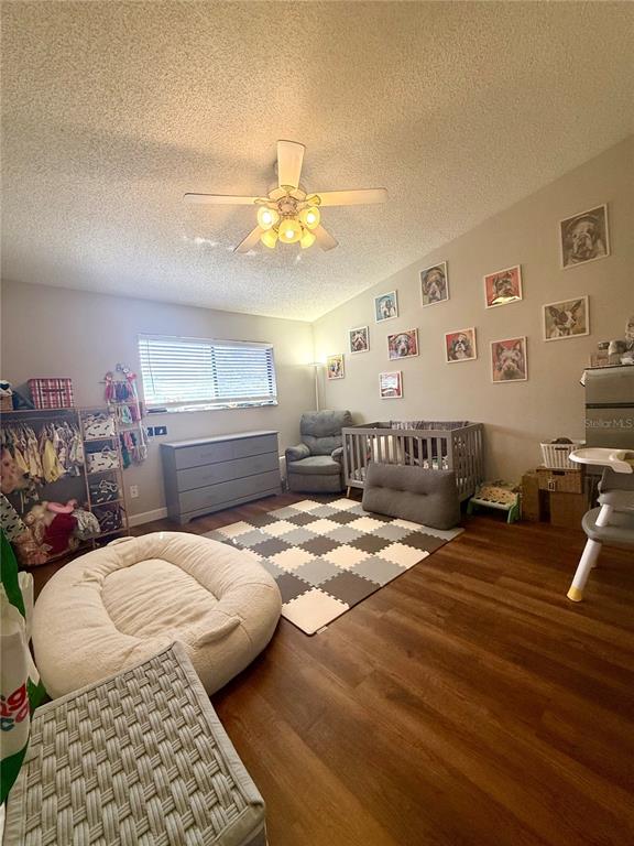 1920 Whitney Way Clearwater, FL 33760 - Photo 16 of 38 a bedroom with a bed and ceiling fan