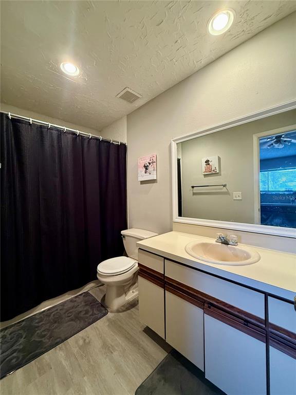 1920 Whitney Way Clearwater, FL 33760 - Photo 18 of 38 a bathroom with a sink a toilet and shower