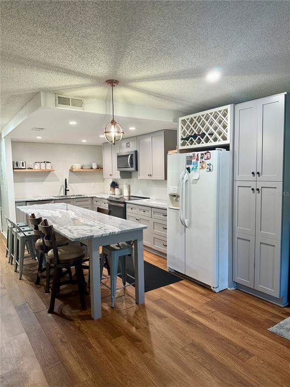 1920 Whitney Way Clearwater, FL 33760 - Photo 9 of 38 a kitchen with stainless steel appliances a dining table chairs refrigerator and sink