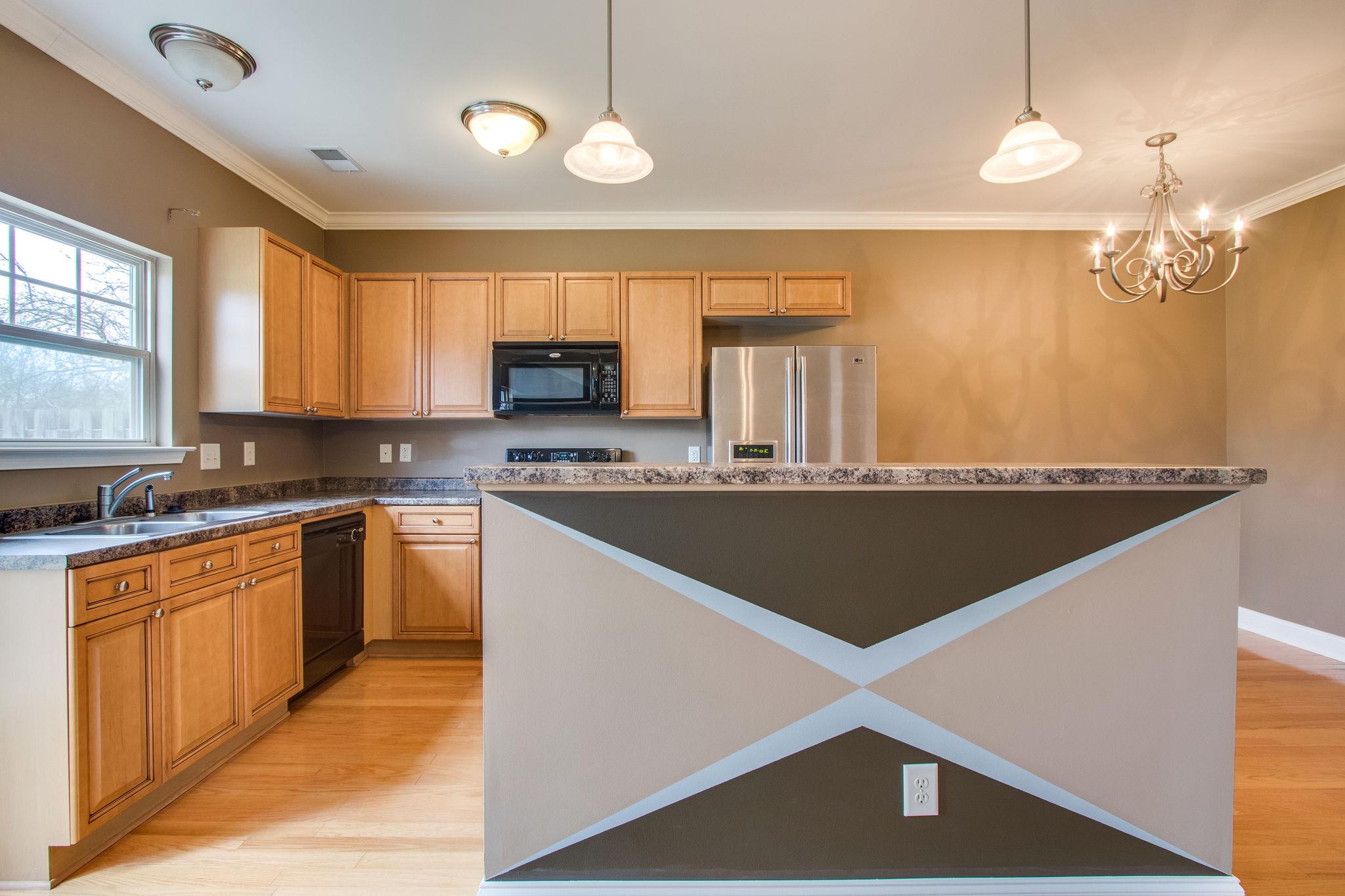 735 Tulip Grove Road, Unit 237 Hermitage, TN 37076 - Photo 11 of 29 a kitchen with stainless steel appliances granite countertop a sink a stove top oven a counter space and cabinets