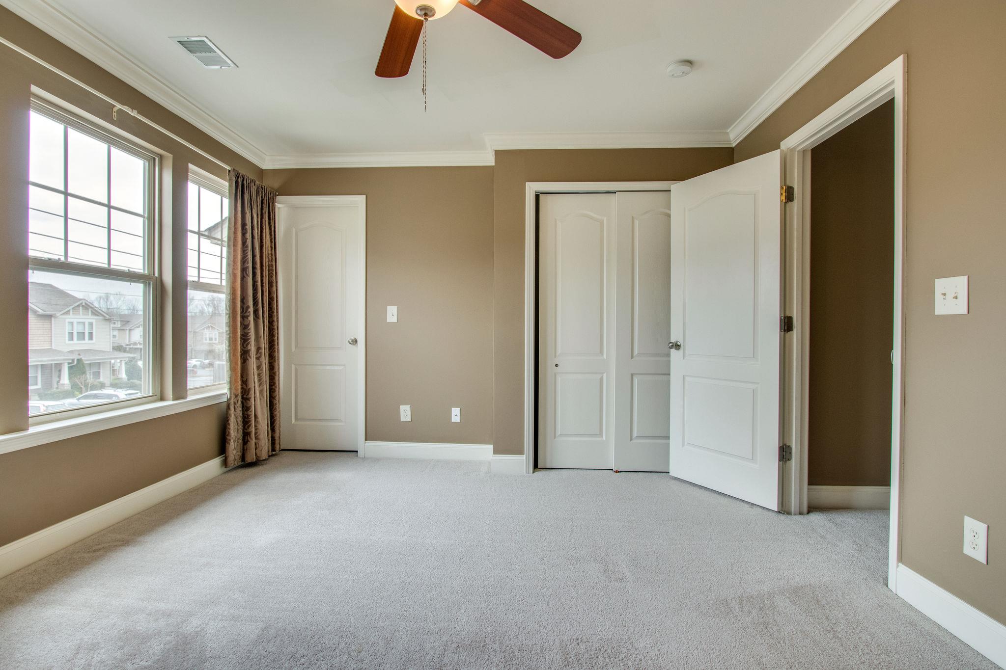 735 Tulip Grove Road, Unit 237 Hermitage, TN 37076 - Photo 18 of 29 an empty room with windows and closet