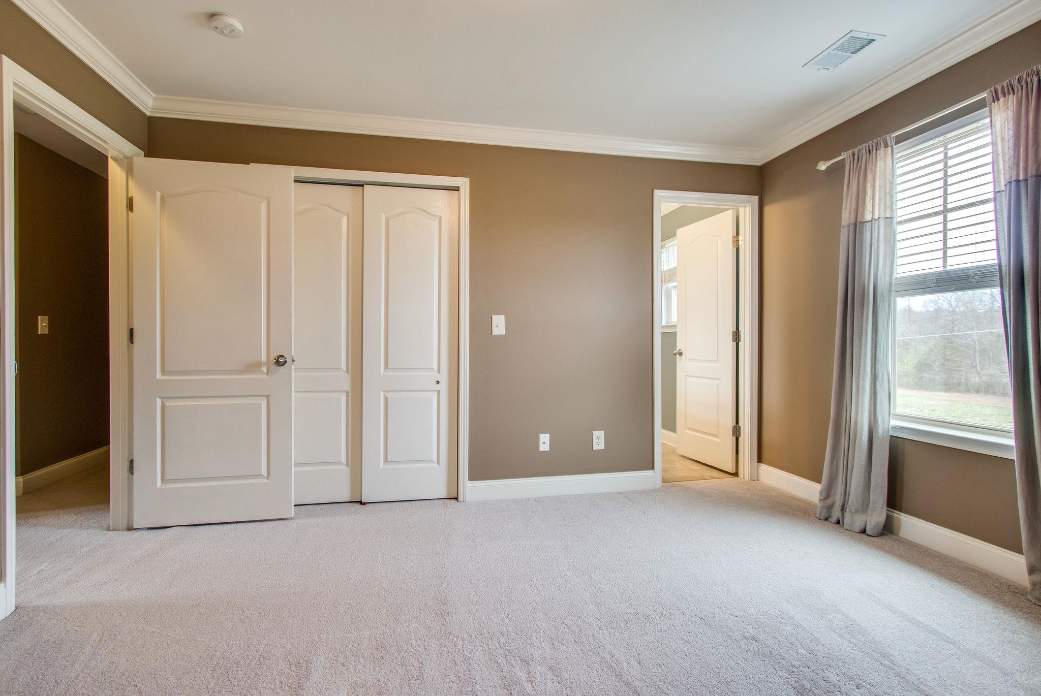 735 Tulip Grove Road, Unit 237 Hermitage, TN 37076 - Photo 23 of 29 an empty room with windows and closet