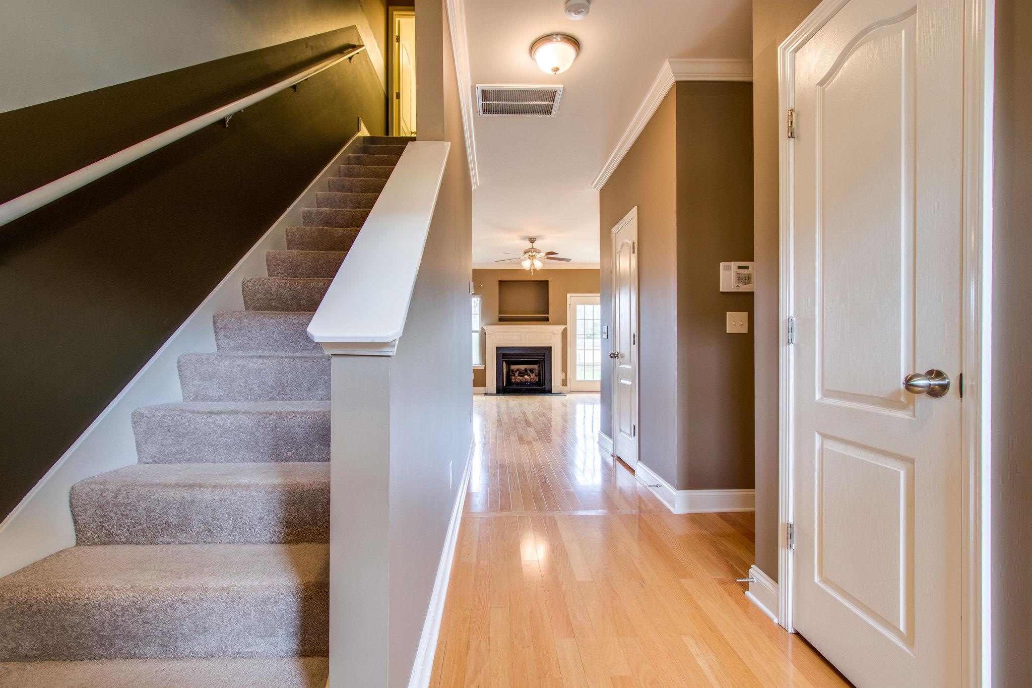 735 Tulip Grove Road, Unit 237 Hermitage, TN 37076 - Photo 5 of 29 a view of a hallway with wooden floor and staircase