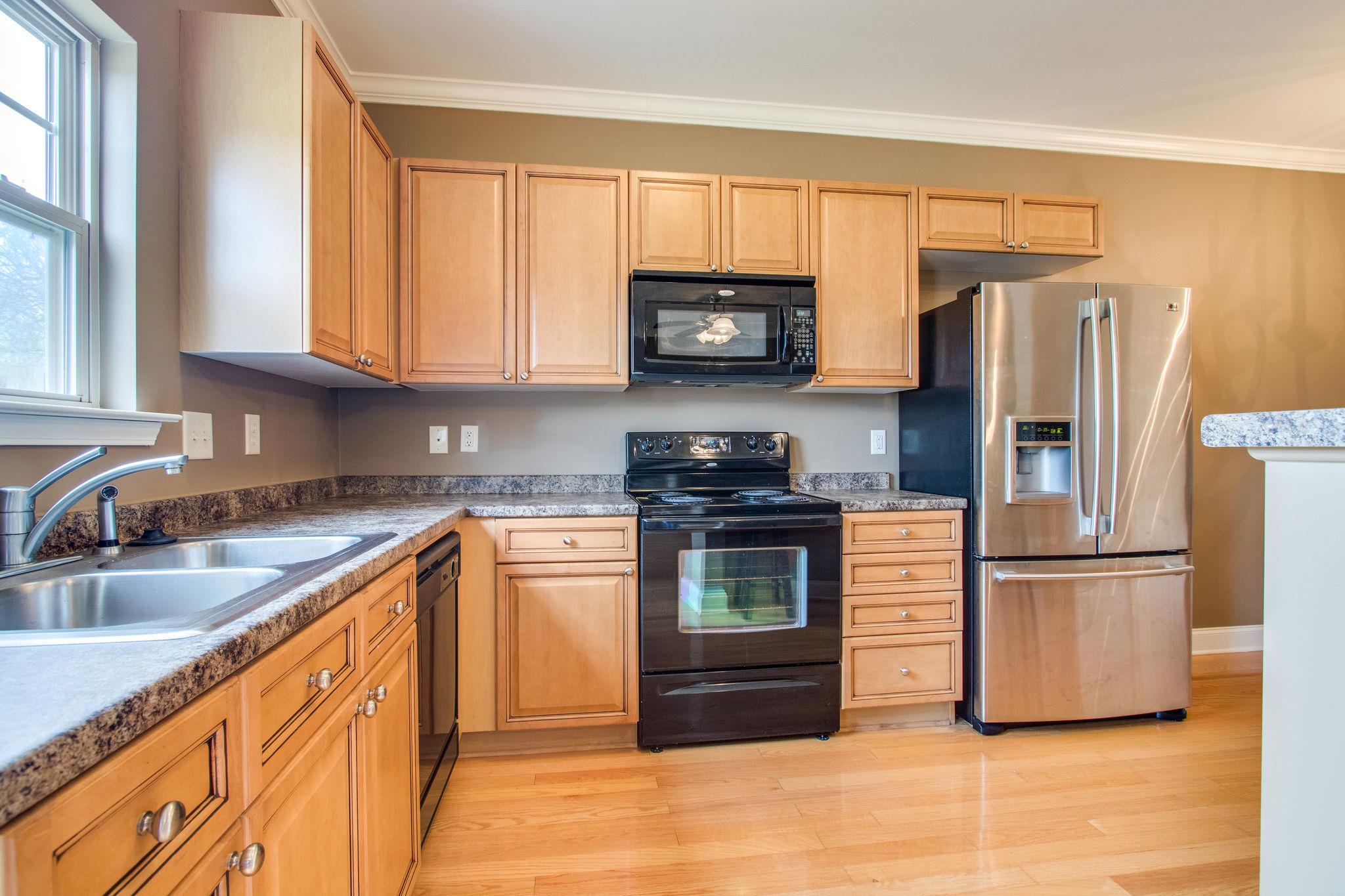 735 Tulip Grove Road, Unit 237 Hermitage, TN 37076 - Photo 10 of 29 a kitchen with stainless steel appliances granite countertop a refrigerator stove and sink