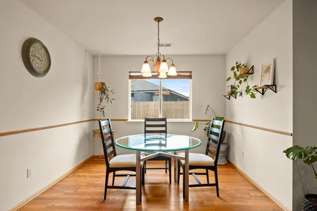 a bedroom with a bed and a flat tv screen on dresser