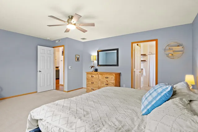 a bathroom with a double vanity sink mirror and toilet
