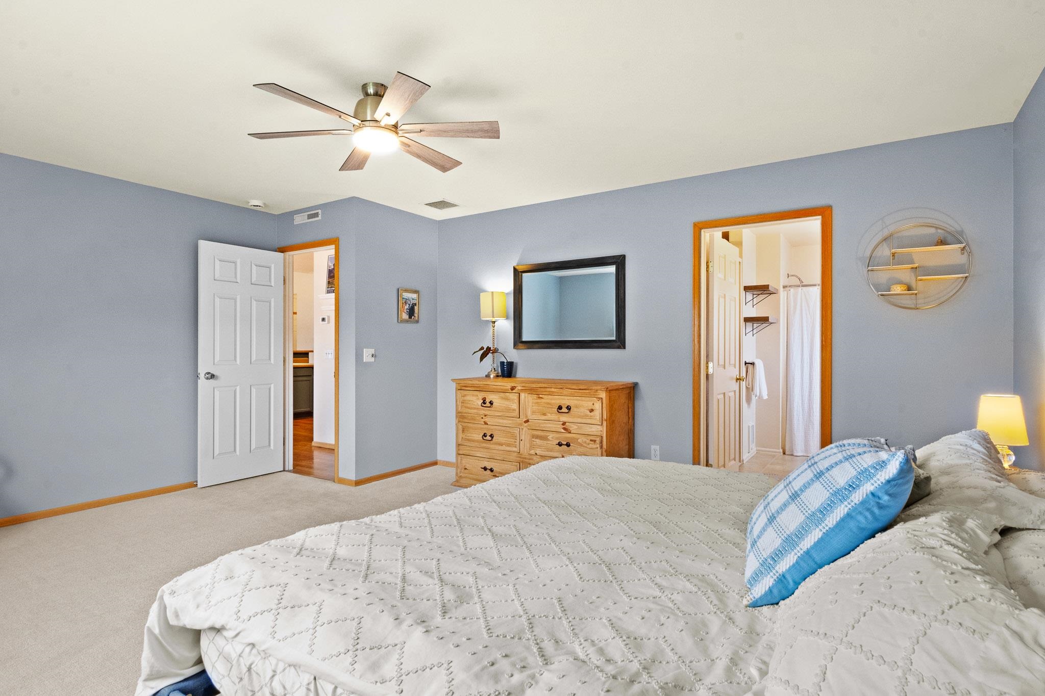 912 Kaley Street Fruita, CO 81521 - Photo 12 of 32 a bedroom with a bed and a flat tv screen on dresser