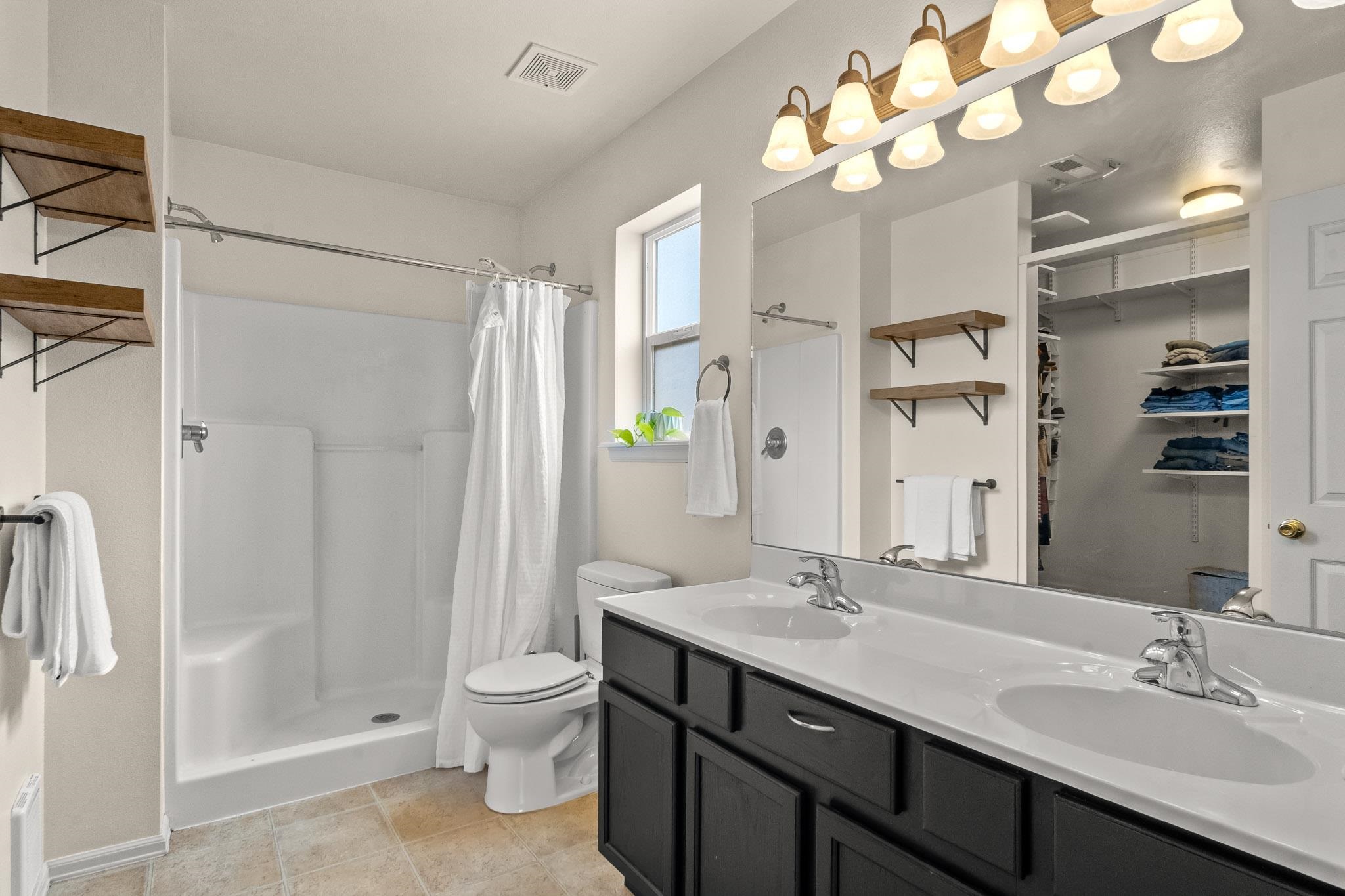 912 Kaley Street Fruita, CO 81521 - Photo 13 of 32 a bathroom with a double vanity sink mirror and toilet
