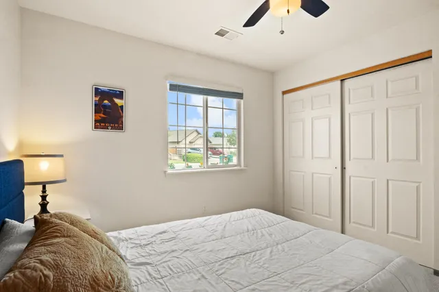 a bedroom with a bed and a chandelier