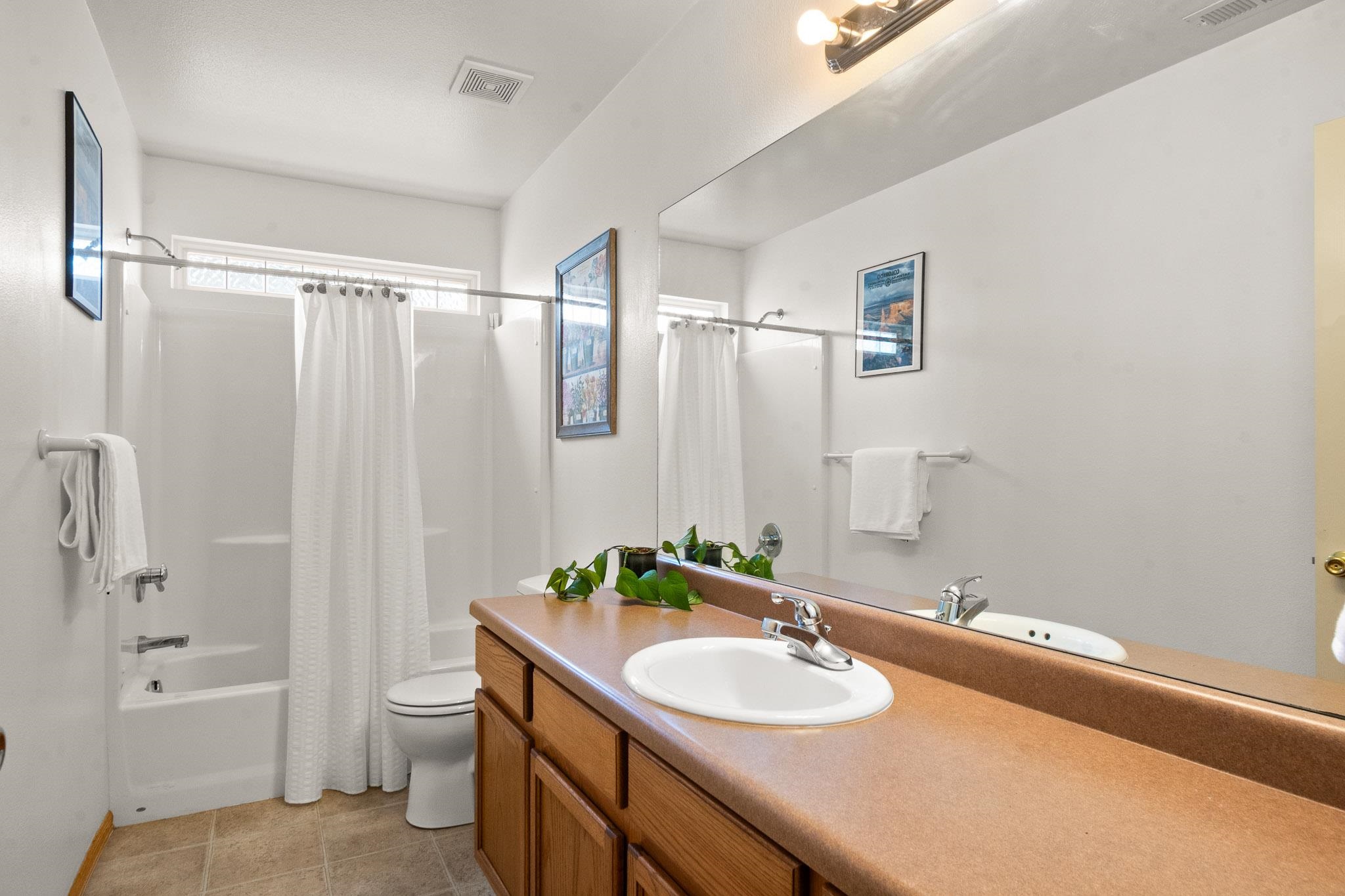 912 Kaley Street Fruita, CO 81521 - Photo 16 of 32 a bathroom with a granite countertop sink and a mirror