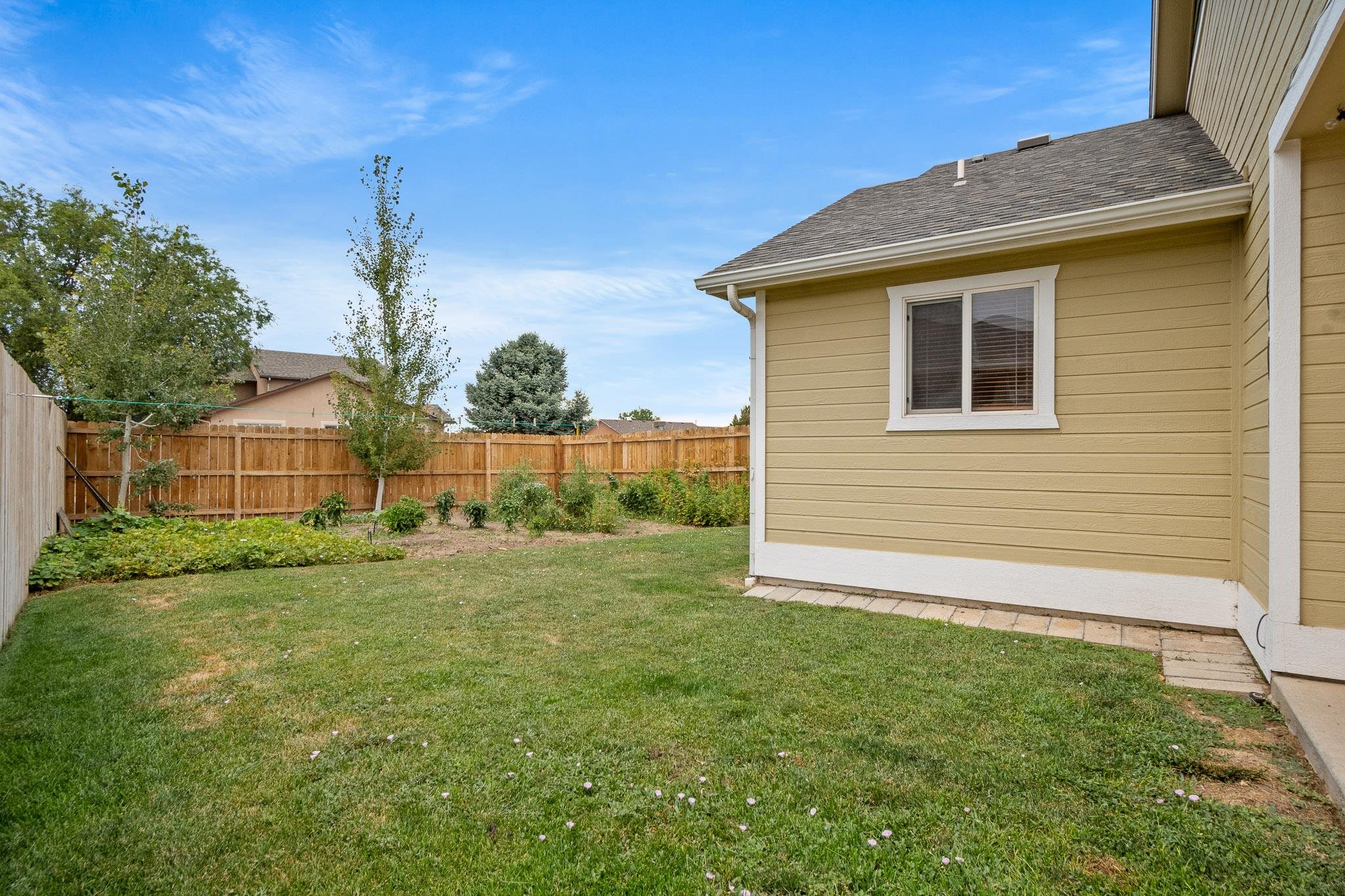 912 Kaley Street Fruita, CO 81521 - Photo 21 of 32 a view of a house with a backyard