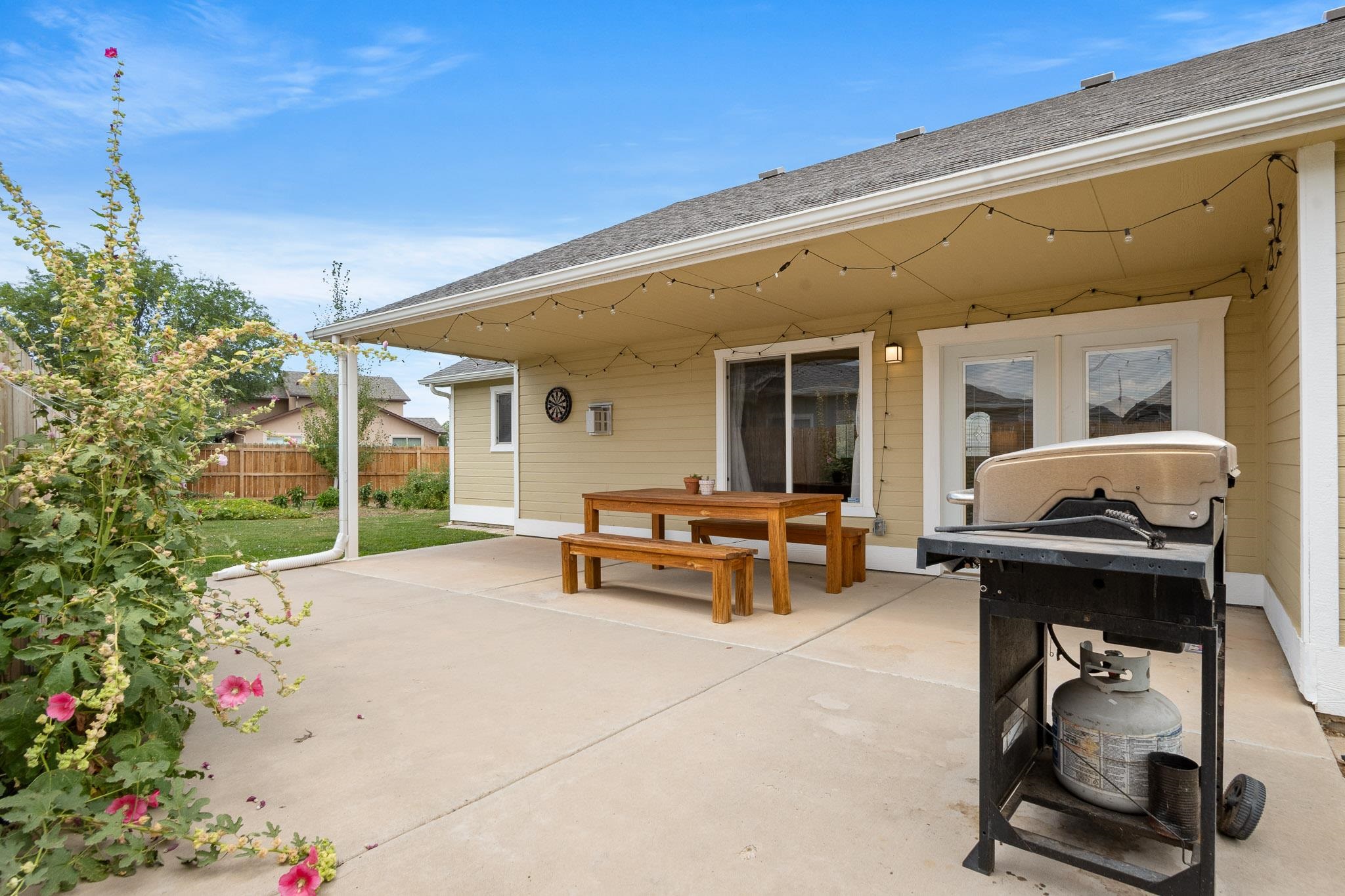 912 Kaley Street Fruita, CO 81521 - Photo 6 of 32 a patio with a table and chairs and potted plants