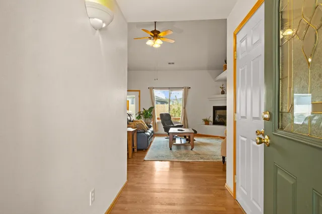 a living room with furniture kitchen view and a chandelier