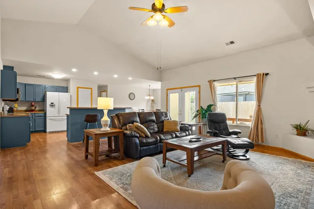 a kitchen with kitchen island granite countertop wooden floors and stainless steel appliances