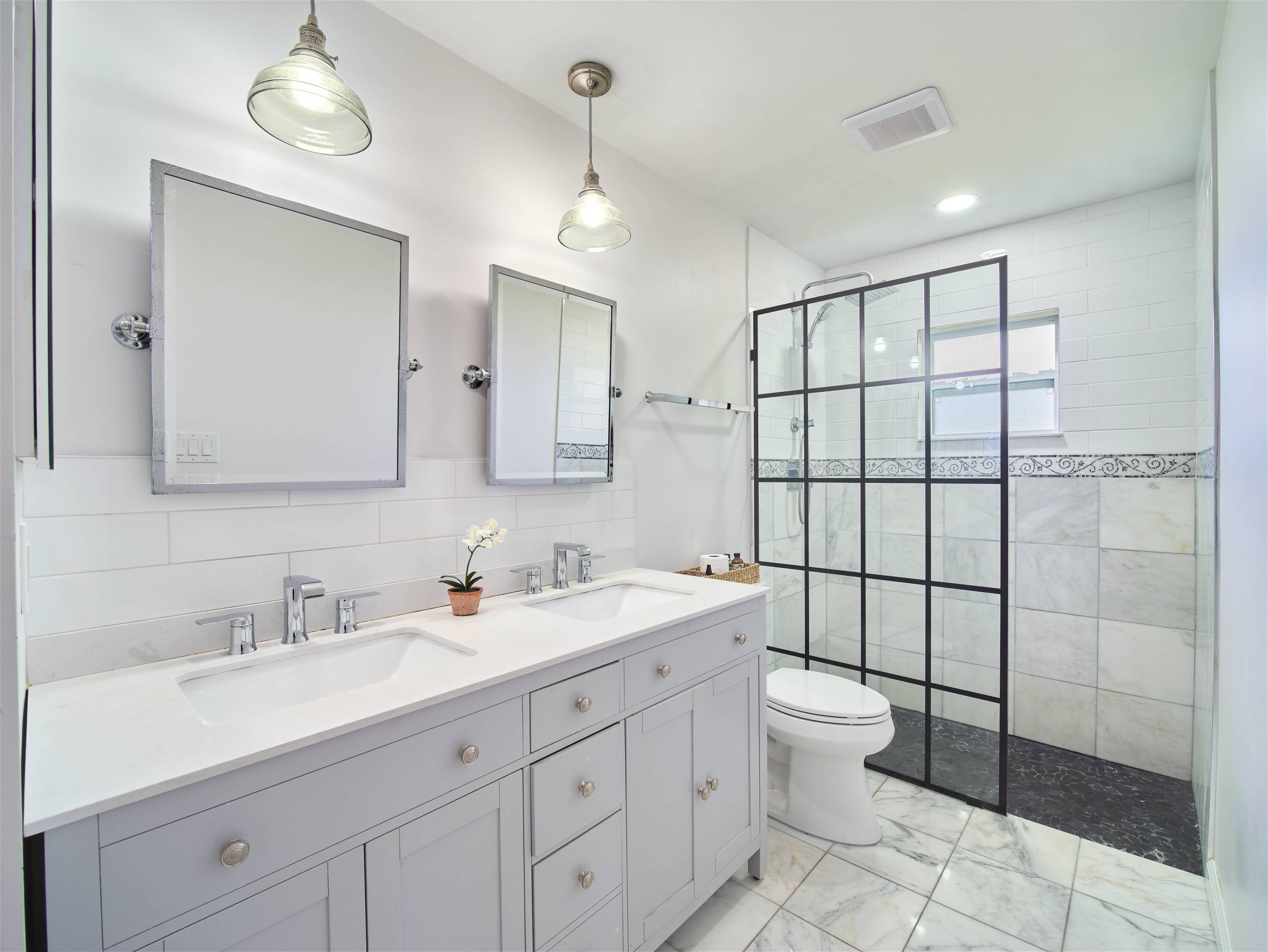 359 Church Road Tequesta, FL 33469 - Photo 13 of 30 a bathroom with a double vanity sink mirror and toilet