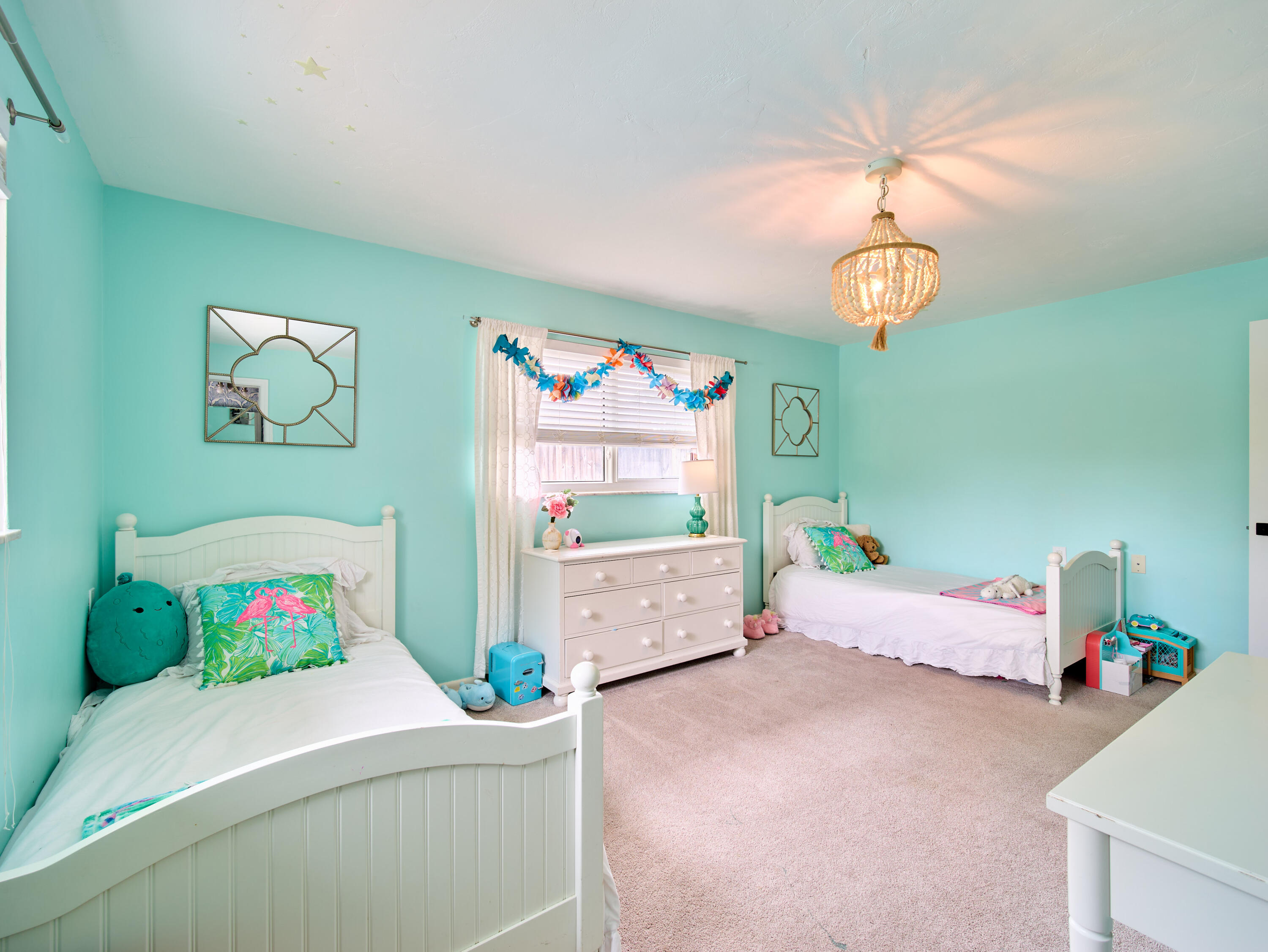 359 Church Road Tequesta, FL 33469 - Photo 18 of 30 a bedroom with a bed and a chandelier